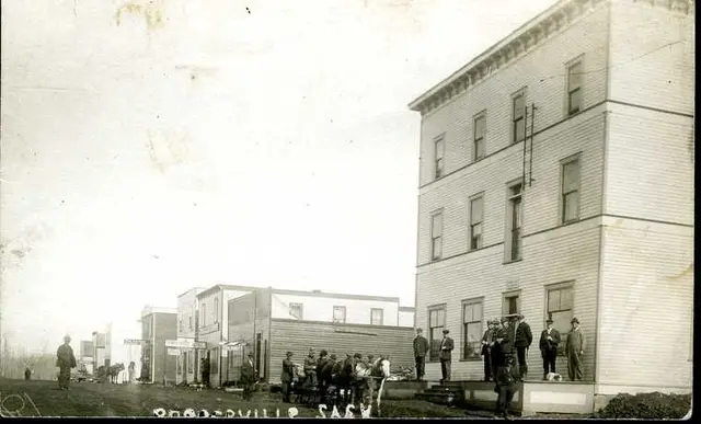 Street scene with a large three-storey building and townspeople
