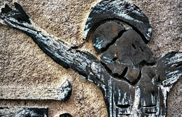 Carved relief figure on a stone monument at Conjuring Creek cemetery